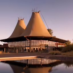 the building has three triangular roof and some buildings with several different structures on top