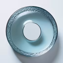 the light blue bowl has been arranged like a circular object