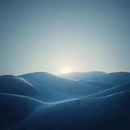 a mountain range covered in snow at dusk with the sun shining through the clouds