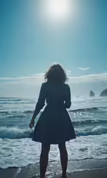 a woman is standing in the surf with her arms up