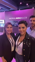a couple of women standing next to a man
