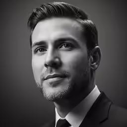 black and white photograph of a well - dressed man