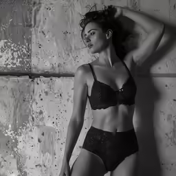 a black and white photo of a woman in lingerie