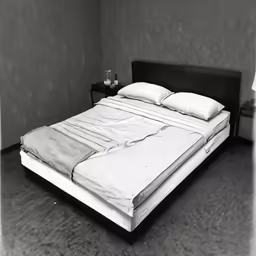 a bed and night stand in an empty room