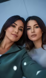 two females in blue and green outfits posing for a photo
