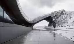 man walking along empty snowy road under the bridge