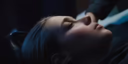 a woman lying down, with her eyes open