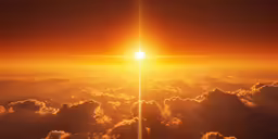 a sun is shining above the clouds at sunset