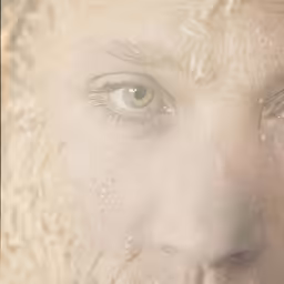 a person with very long curly hair looking to the side