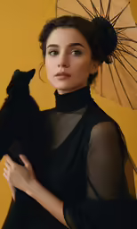 a woman holding a cat with an umbrella on the side