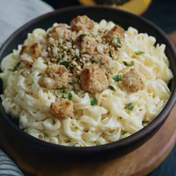 a bowl that is filled with noodles and meatballs