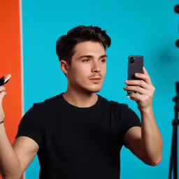 a young man holds up a cell phone