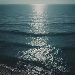 the sun is shining through the water over the ocean