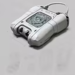 an old device sits on a grey surface