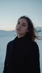 a woman standing on top of snow covered ground