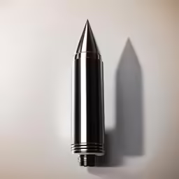 a metal ballpen mounted on the side of a wall