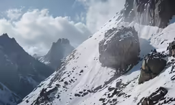 this photo shows the tops of a mountain range that has been completely covered by snow