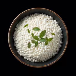 a bowl with some white beads in it