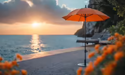 a sunset over the ocean with an umbrella