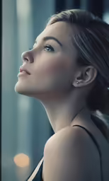 a young woman with her eyes closed looking into the distance
