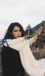 a woman with her arms extended and she is in the air