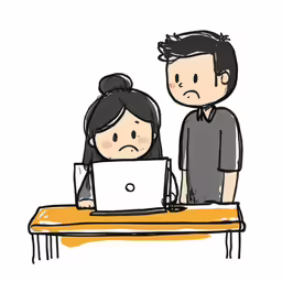a man and woman working on a laptop