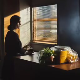 a woman sitting in a window sill beside a window