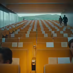 people standing behind some chairs with note pads