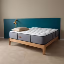 a close up of a mattress in front of a wall