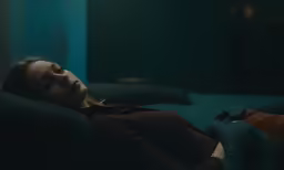 woman sleeping on the couch in the dark