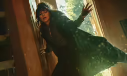 woman dressed in dark fashion next to open windows