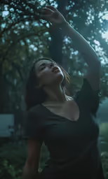 a woman reaching out her arms in a park