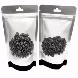 two bags filled with beans on a white surface