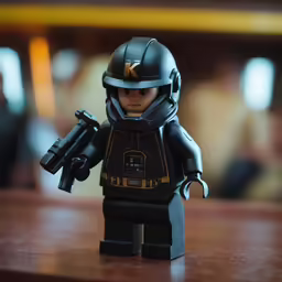 a lego figure with a machine gun in his hand