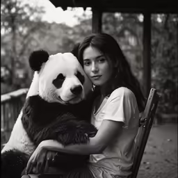 a young woman holding a giant panda bear