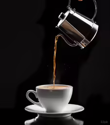 a white cup with a tea strainer on it