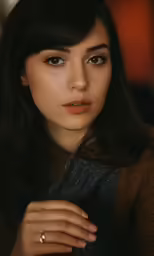 a close - up of a woman with her hands on her lap