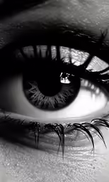 a person with very large eyelashes looking at the camera