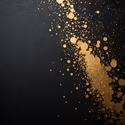 some dots of gold color sprinkled on black background