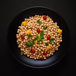 a plate of chickpeas is shown on a black background