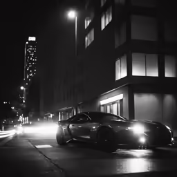 cars on a city street at night with building lights