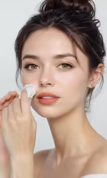 a close up of a woman with white makeup and clump of hair