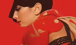 a woman with black hair and red sweater