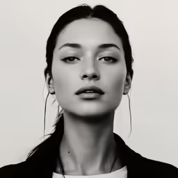 a woman with her eyes closed wearing hoop earrings