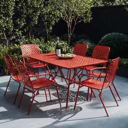 a red table set with six chairs and a bottle of wine