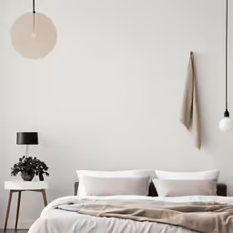 a large bed sitting next to a wall with lights