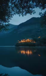 a house on top of a hill sitting on a lake at night