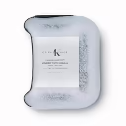 white soap bar in a black holder with an ad for a k soap company