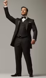 a man in a suit stands and waves to someone