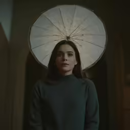 the woman is wearing an umbrella hat